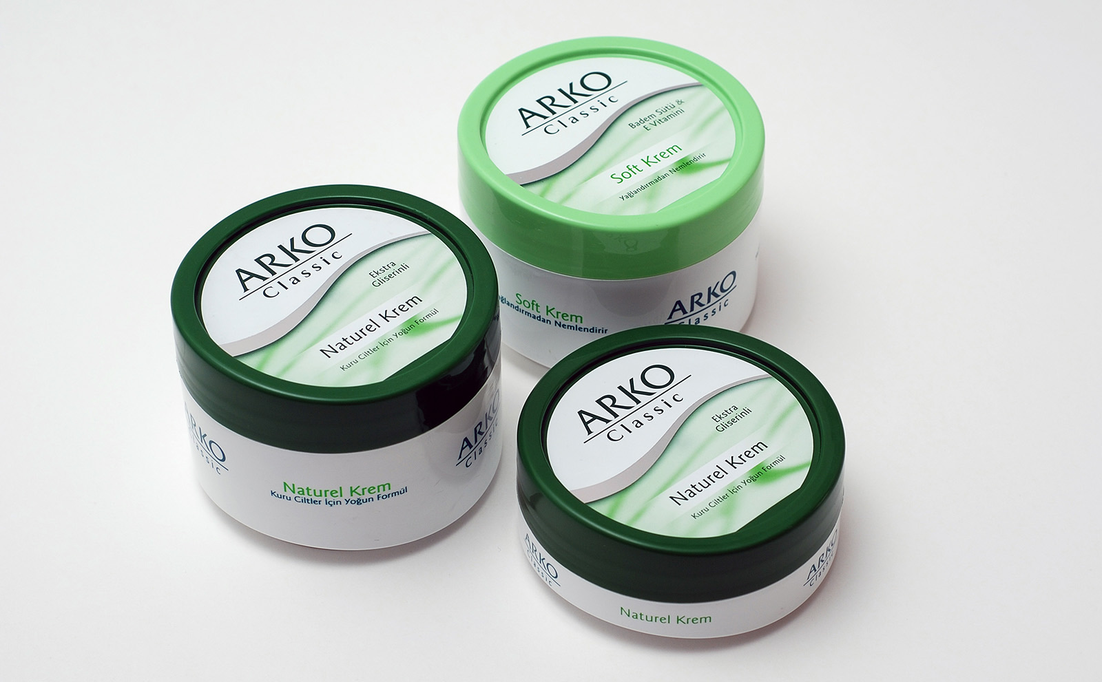 Arko cream tins in green and white